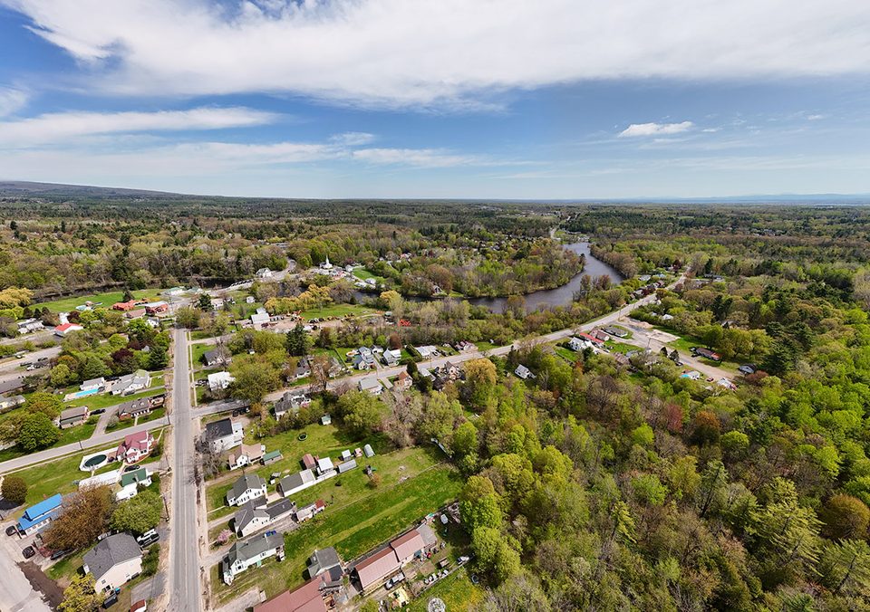 River bend and bridge beside Morrisonville homes, photographed in May 2026